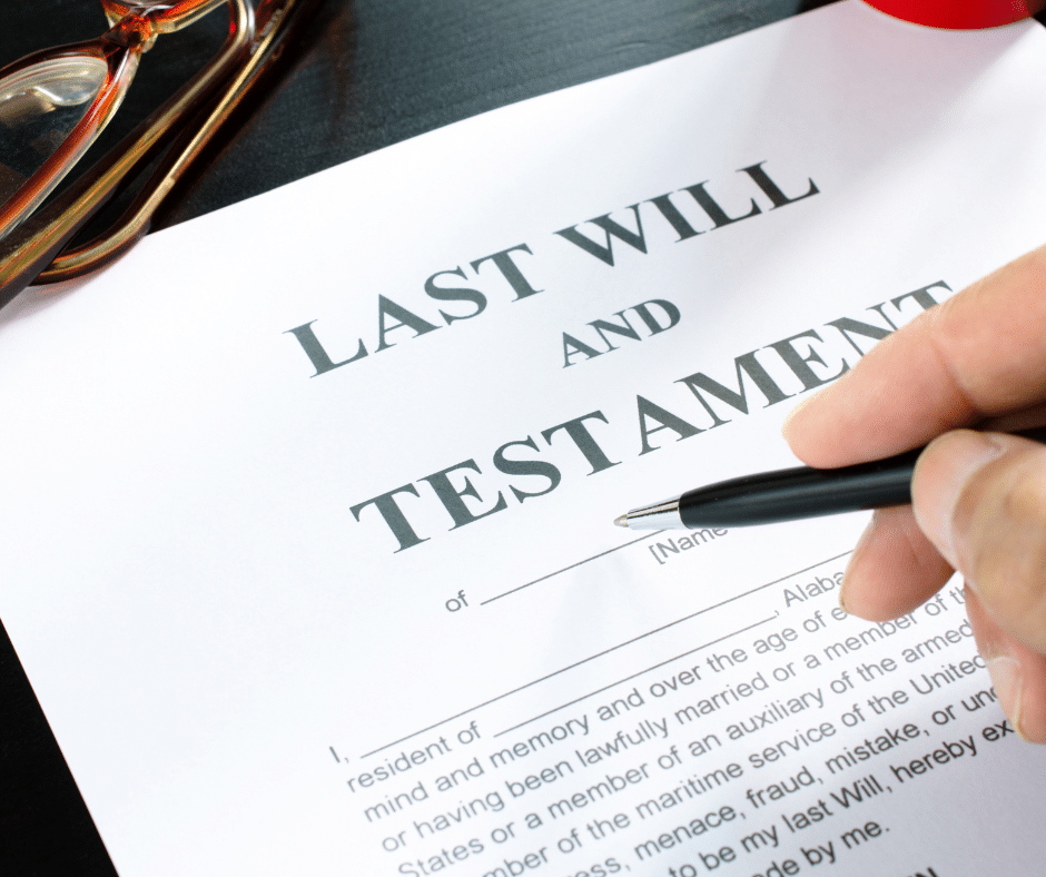 Last Will and Testament on white paper with a black ink pen poised to sign.